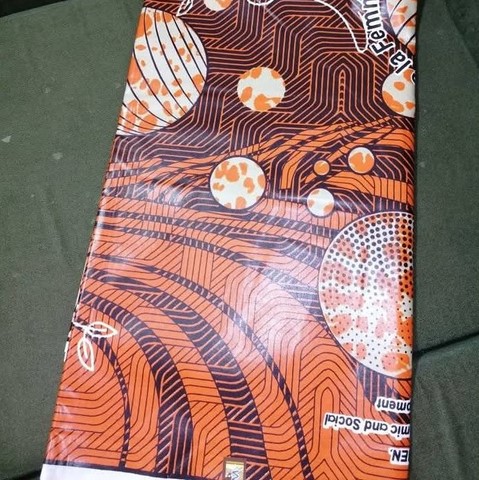 Tissu pagne wax, orange, pagne du 8 mars 2024 officiel (la journée internationale de la femme au Cameroun) Cicam,